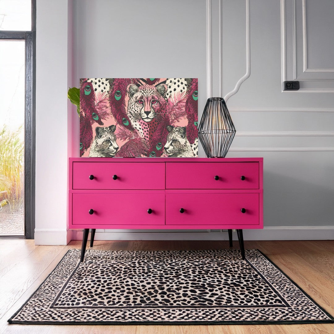 a pink four- drawer dresser with a leopard print rug on the floor in front of it. The dresser has a unique design with a geometric pattern on the front.